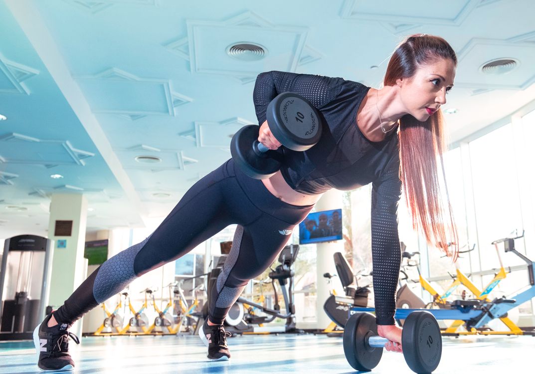 Client running on treadmill with trainer